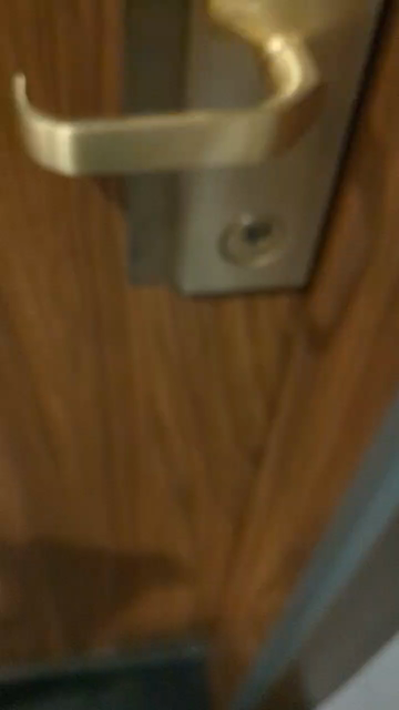 A flipper zero emulating a copied NFC room key opening a hotel door