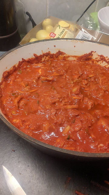 A big dutch oven almost full of homemade kimchi
