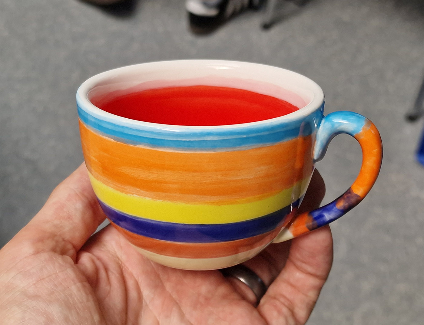 Photo of a cup with colorful bands around its circumference.