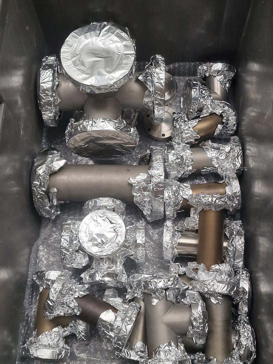 Photo of a box full of CF flange parts.