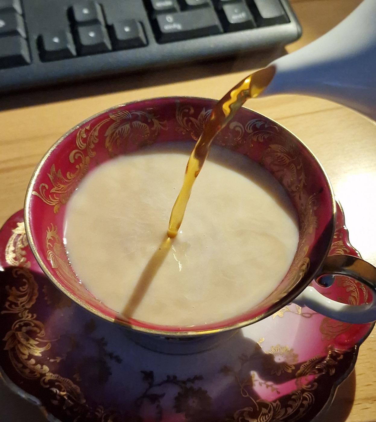 Photo of Earl Grey being poured into an ornate cup. The color clearly suggests that this person pours the milk first, but I honestly don't care which way around one does it. And neither should you.