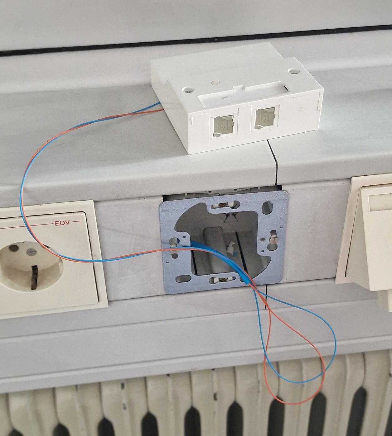 Photo of a fiber port that has become rather obviously detached from its attachment point.
